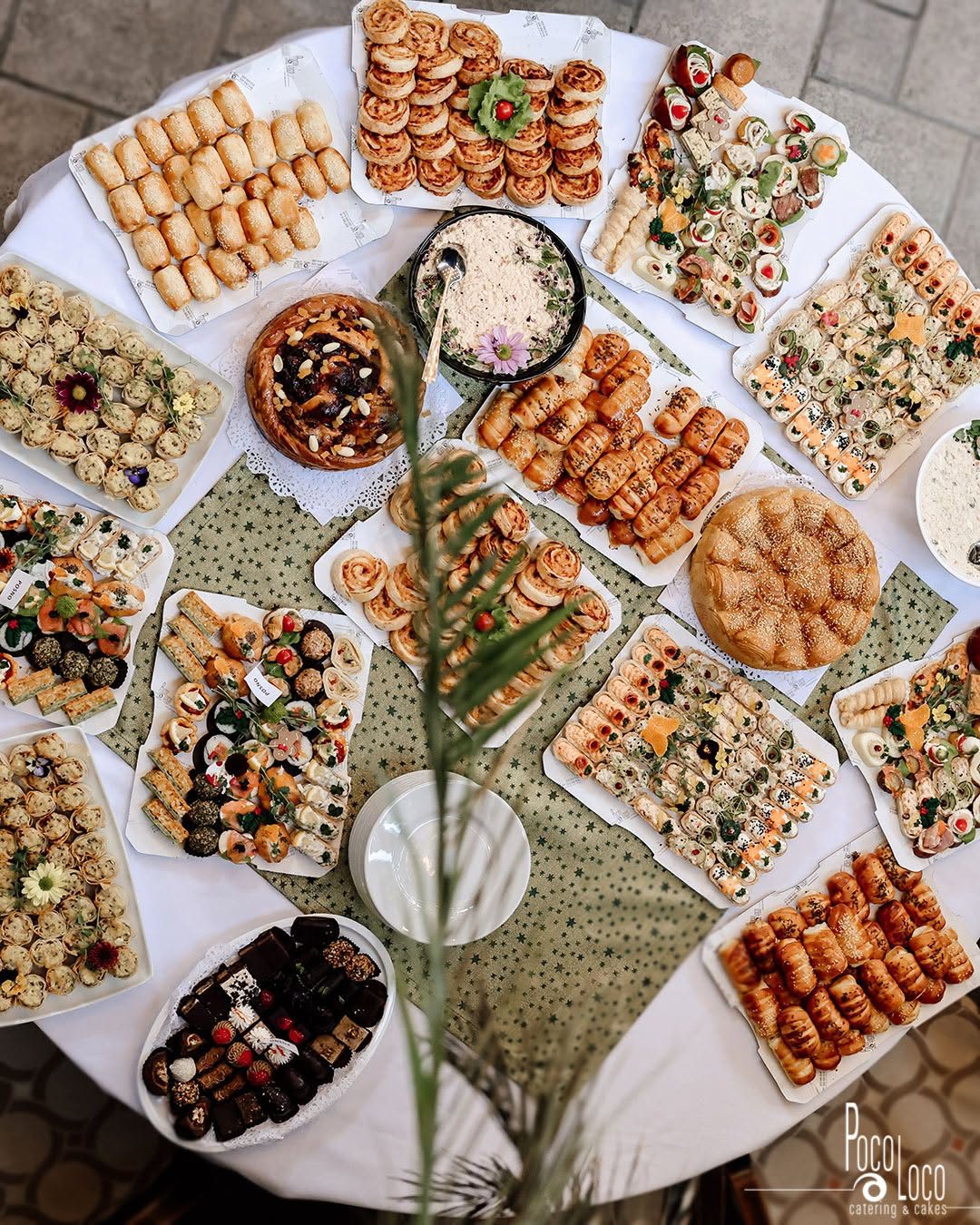 Okrugli sto odozgo — desetak platoa sa slanim pecivima, rolnicama, namazom i sitnim kolačima